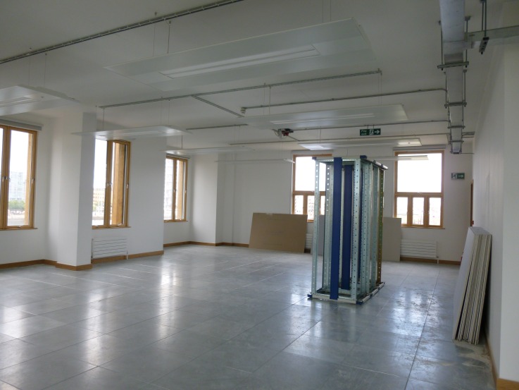 The wider shell, freshly painted, awaiting fit-out. The three cabinets we've brought across are parked in the middle