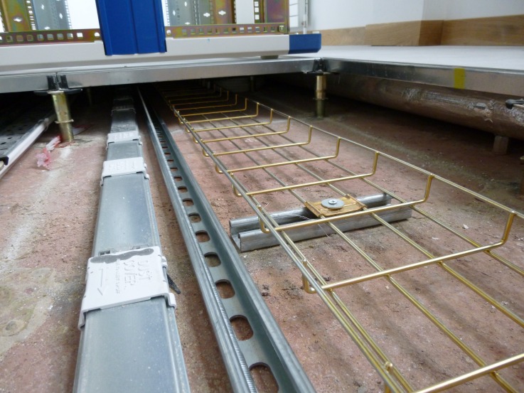 Inside the comms room: cable basket and trunking under the raised floor