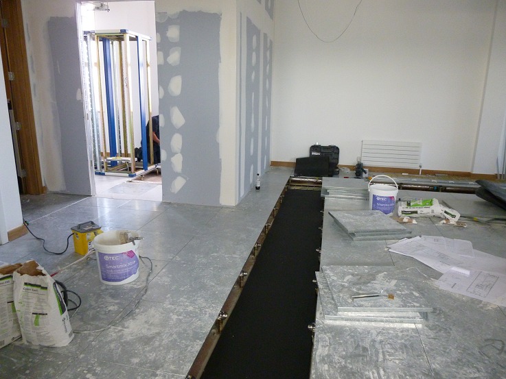 Matting laid along the route the patch cables will take from the floor boxes back to the comms room