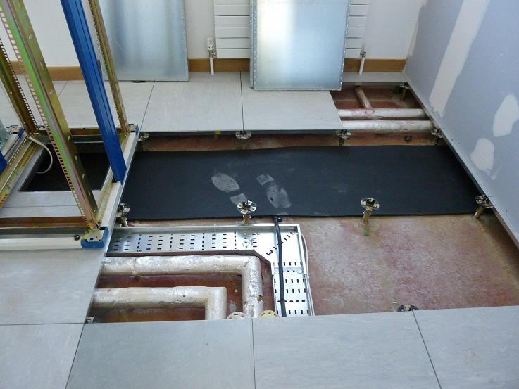 Insulated heating pipework running directly under the rack footprint