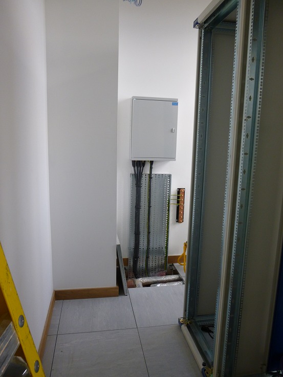 Power distribution board, cable tray, and copper earth bar on the far wall