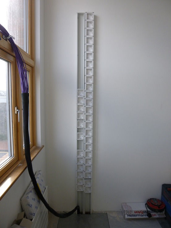 Power and data dado trunking under construction, ready to supply the steel shelving
