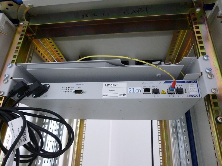 BT OpenReach FSP150CP NTE, labelled 21cn, lit on a yellow patch lead
