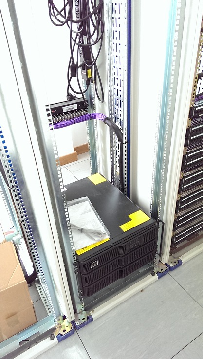 The UPS sits at the base of the rack
