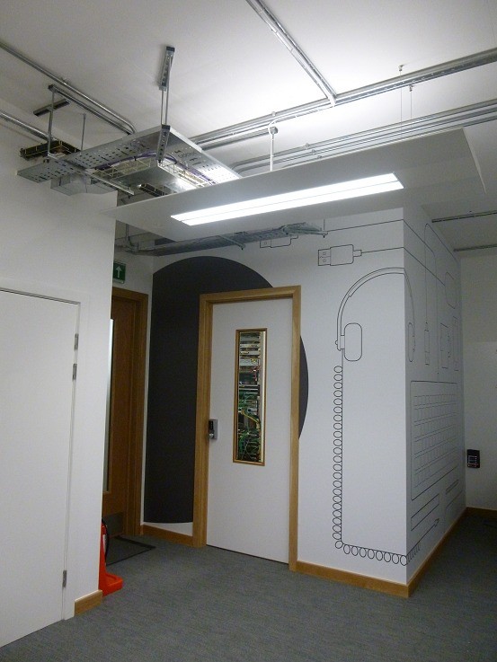 The completed comms room door, headphones mural alongside
