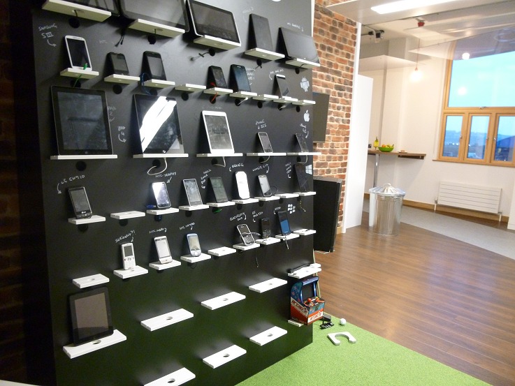 Device test lab, with an arcade cabinet and a putting green for good measure
