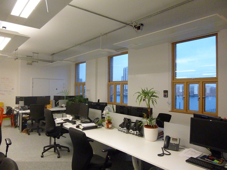 The open-plan floor space in daily use, dockside view through the windows