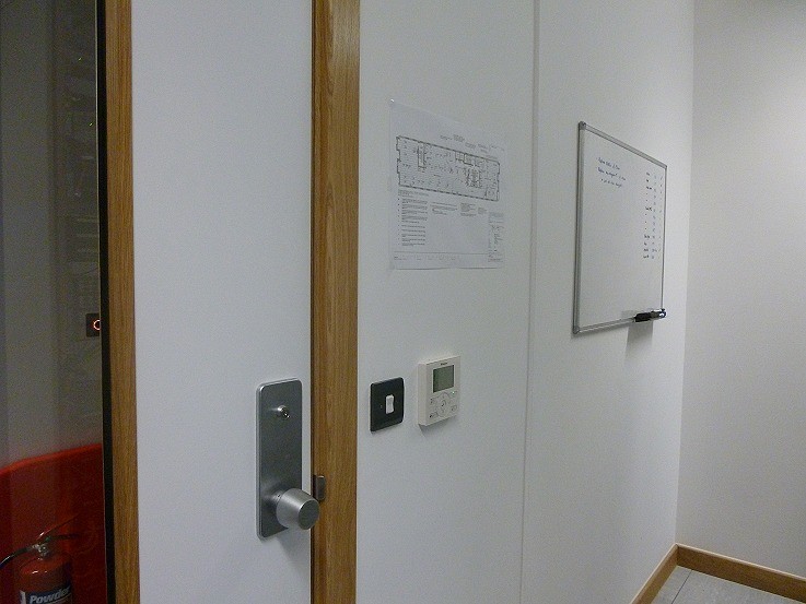 Illustrated floor port map and whiteboard alongside the comms room door